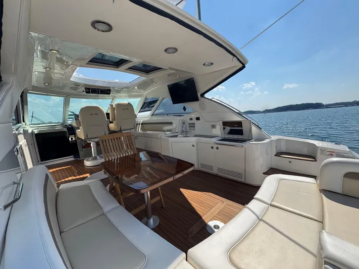 Why Knot Yacht Photos Pics Luxurious 2012 Sea Ray 540 Sundancer yacht interior with seating, table, and scenic water view.