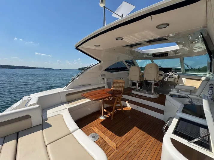 Why Knot Yacht Photos Pics Luxurious 2012 Sea Ray 540 Sundancer yacht interior with seating and helm, on open water.
