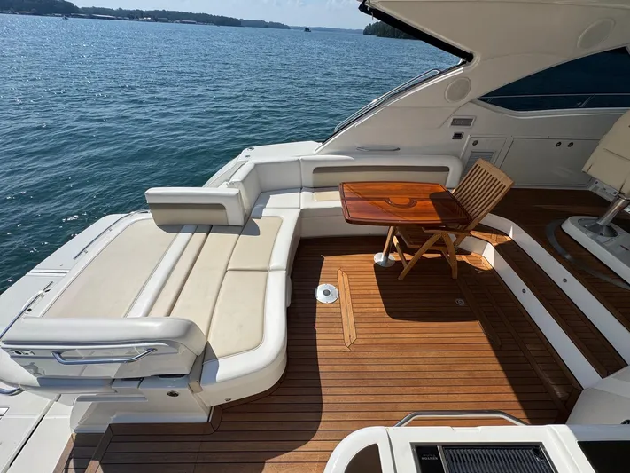 Why Knot Yacht Photos Pics Luxurious 2012 Sea Ray 540 Sundancer yacht deck with seating and wooden table.