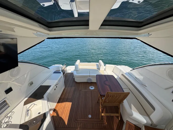 Why Knot Yacht Photos Pics Luxurious 2012 Sea Ray 540 Sundancer yacht interior with elegant seating and wooden deck.