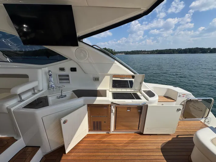 Why Knot Yacht Photos Pics Luxurious 2012 Sea Ray 540 Sundancer yacht interior with kitchenette and scenic water view.