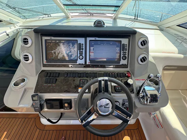 Why Knot Yacht Photos Pics Helm of 2012 Sea Ray 540 Sundancer with dual navigation screens and modern controls.