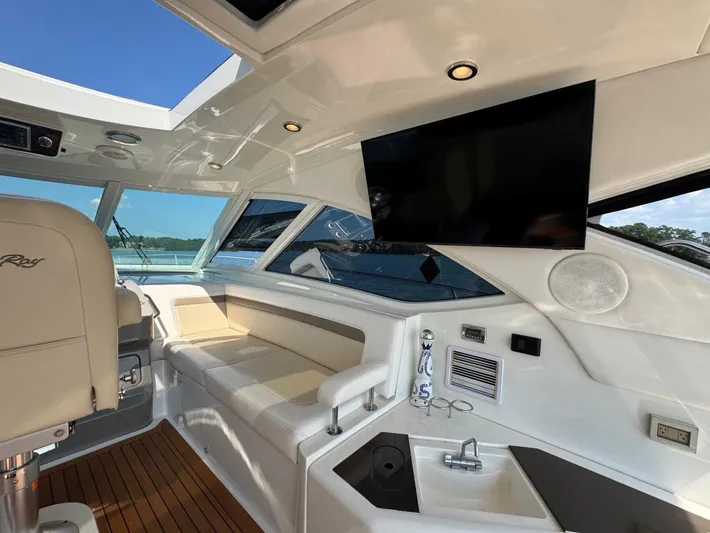 Why Knot Yacht Photos Pics Luxurious interior of 2012 Sea Ray 540 Sundancer yacht with seating and entertainment system.