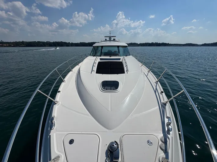 Why Knot Yacht Photos Pics 2012 Sea Ray 540 Sundancer yacht cruising on a sunny day with clear skies.