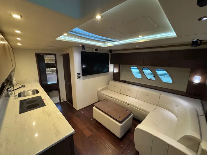 Why Knot Yacht Photos Pics Luxurious interior of 2012 Sea Ray 540 Sundancer yacht with modern kitchen and seating area.