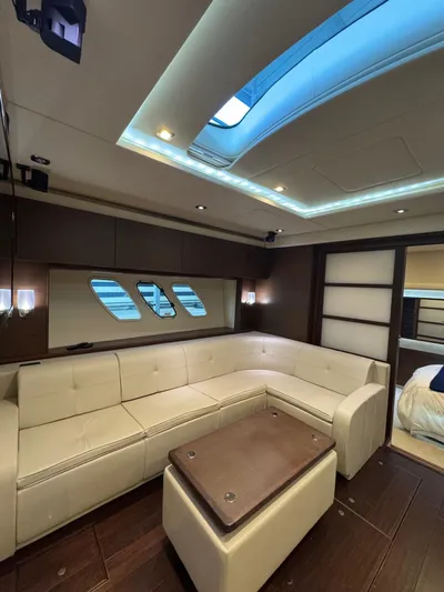 Why Knot Yacht Photos Pics Luxurious interior of 2012 Sea Ray 540 Sundancer yacht with plush seating and skylight.