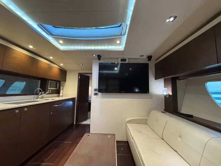 Why Knot Yacht Photos Pics Luxurious interior of 2012 Sea Ray 540 Sundancer yacht with modern kitchen and seating area.