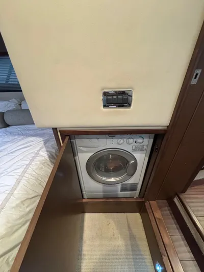 Why Knot Yacht Photos Pics Compact laundry area in 2012 Sea Ray 540 Sundancer yacht, featuring a built-in washing machine.