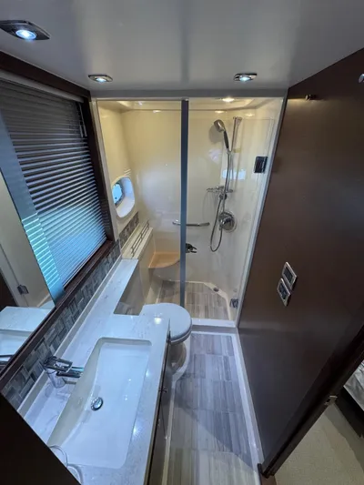 Why Knot Yacht Photos Pics Luxurious bathroom in 2012 Sea Ray 540 Sundancer yacht with modern fixtures and shower.