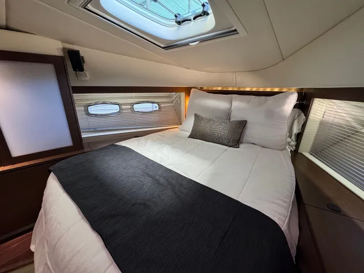 Why Knot Yacht Photos Pics Luxurious cabin interior of 2012 Sea Ray 540 Sundancer yacht with skylight and cozy bedding.