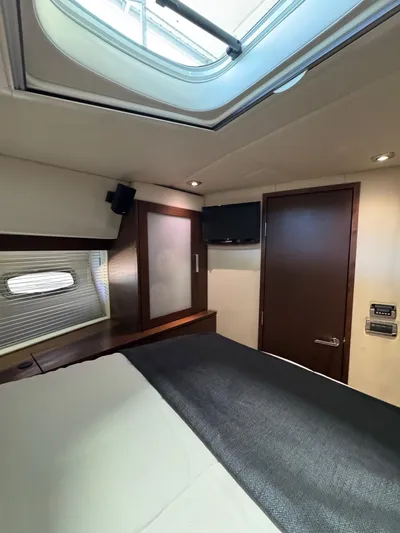 Why Knot Yacht Photos Pics Luxurious cabin interior of 2012 Sea Ray 540 Sundancer yacht with skylight and TV.