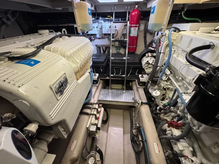 Why Knot Yacht Photos Pics Engine room of 2012 Sea Ray 540 Sundancer yacht, featuring dual engines and equipment.