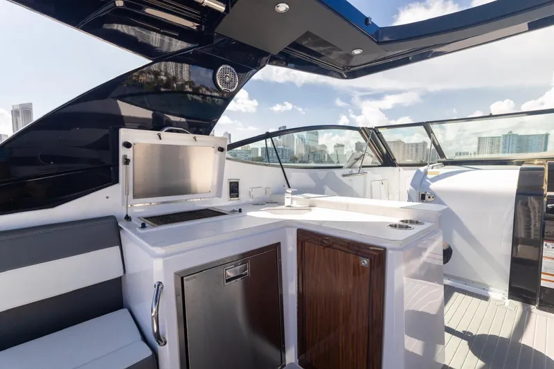  Yacht Photos Pics Luxurious 2022 New Cruiser Yachts GLS 38 interior with sleek kitchen and city skyline view.