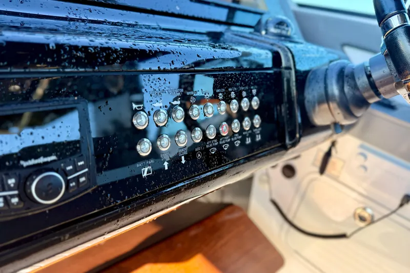  Yacht Photos Pics Control panel of 2022 New Cruiser Yachts GLS 38, featuring buttons and steering wheel.