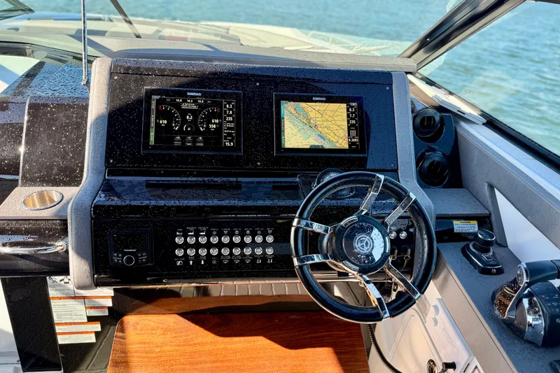  Yacht Photos Pics Cockpit of 2022 New Cruiser Yachts GLS 38 with navigation displays and steering wheel.