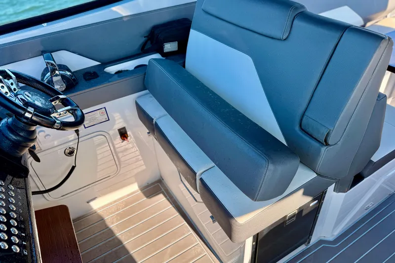  Yacht Photos Pics Captain's seat and helm of 2022 New Cruiser Yachts GLS 38, featuring modern controls.