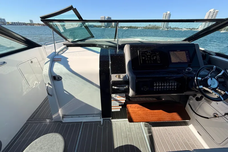  Yacht Photos Pics 2022 New Cruiser Yachts GLS 38 helm with modern controls, steering wheel, and waterfront view.