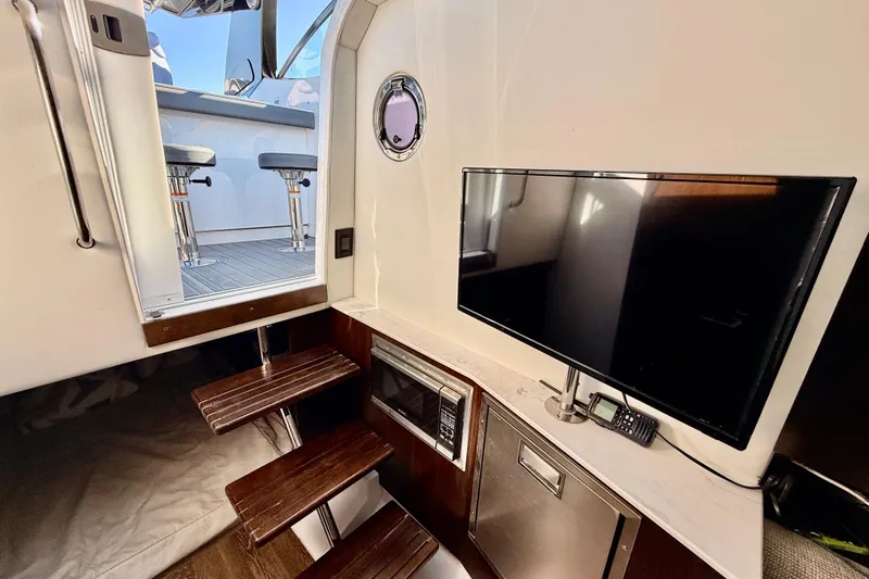  Yacht Photos Pics Interior of 2022 New Cruiser Yachts GLS 38 with TV, microwave, and stairs to deck.