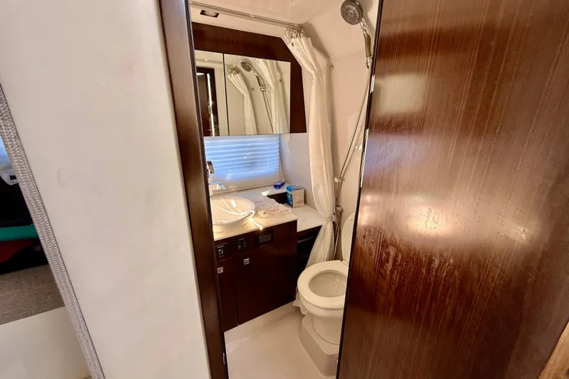  Yacht Photos Pics Luxurious bathroom in 2022 New Cruiser Yachts GLS 38, featuring modern fixtures and elegant wood finishes.