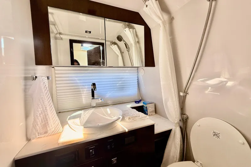  Yacht Photos Pics Luxurious bathroom in 2022 New Cruiser Yachts GLS 38, featuring modern sink and fixtures.