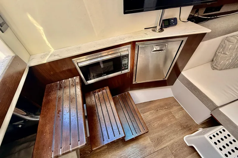  Yacht Photos Pics Interior of 2022 New Cruiser Yachts GLS 38 with microwave and wooden steps.