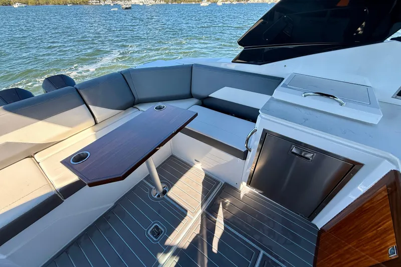  Yacht Photos Pics Luxurious 2022 New Cruiser Yachts GLS 38 interior with seating and table on the water.
