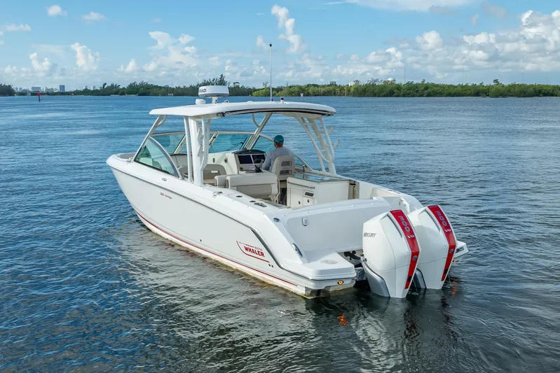 Trade In-- Bring All Offers & Trades Yacht Photos Pics 2024 Boston Whaler 320 Vantage boat on calm water, featuring dual Mercury engines.