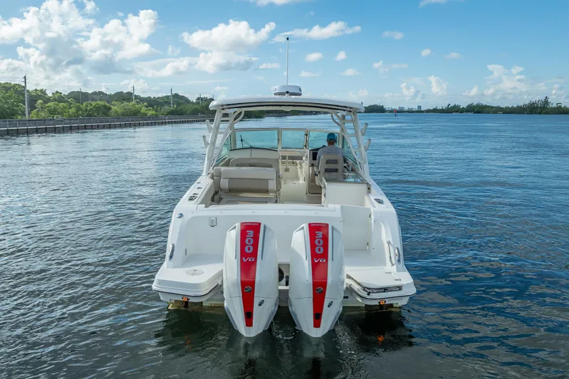 Trade In-- Bring All Offers & Trades Yacht Photos Pics 2024 Boston Whaler 320 Vantage boat on calm water, rear view with twin engines.
