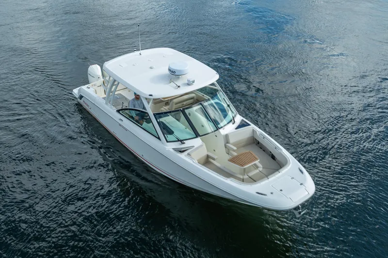 Trade In-- Bring All Offers & Trades Yacht Photos Pics 2024 Boston Whaler 320 Vantage boat cruising on open water.