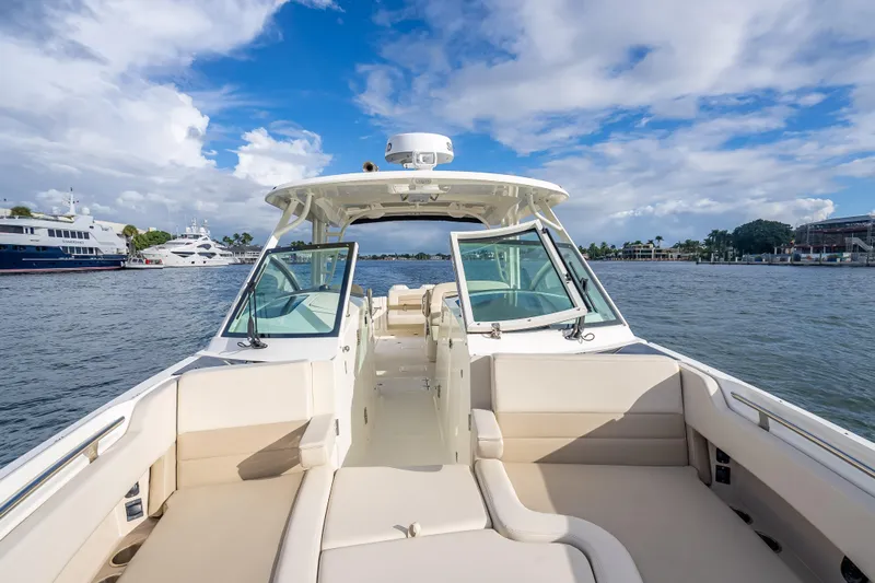 Trade In-- Bring All Offers & Trades Yacht Photos Pics 2024 Boston Whaler 320 Vantage boat on water, open deck, clear sky, luxury yachts nearby.
