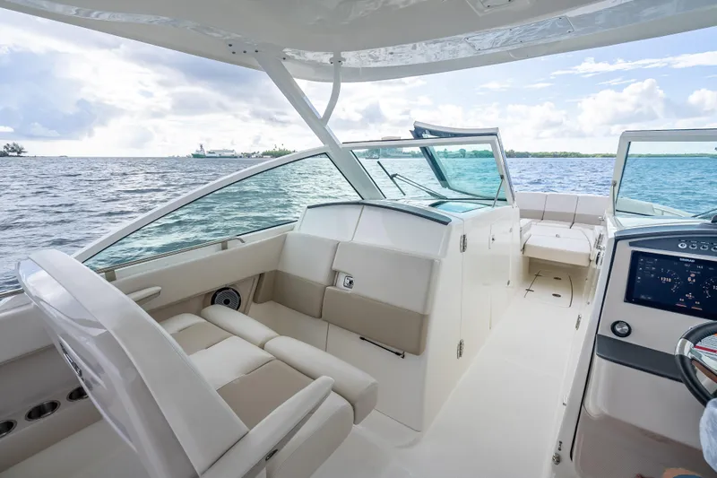 Trade In-- Bring All Offers & Trades Yacht Photos Pics 2024 Boston Whaler 320 Vantage boat interior with seating and dashboard, on open water.