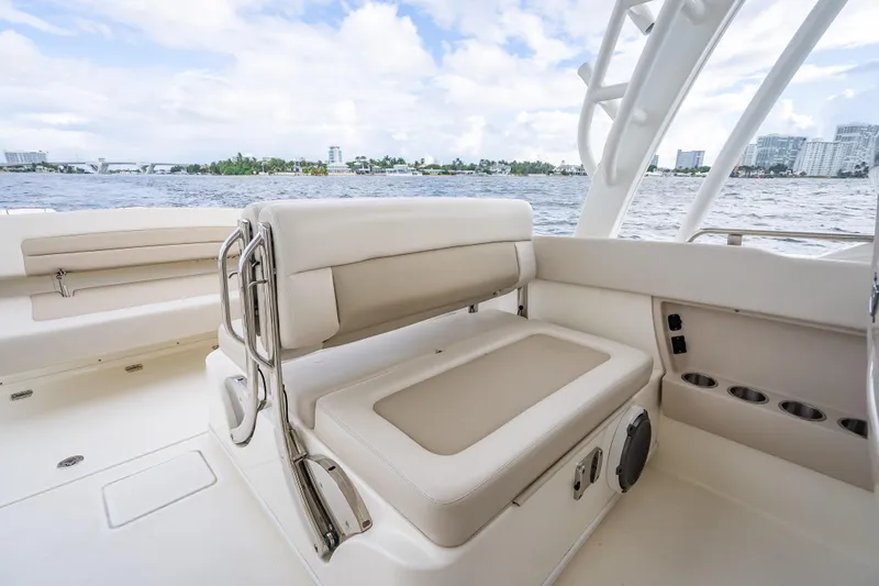 Trade In-- Bring All Offers & Trades Yacht Photos Pics 2024 Boston Whaler 320 Vantage boat interior with seating, cup holders, and ocean view.