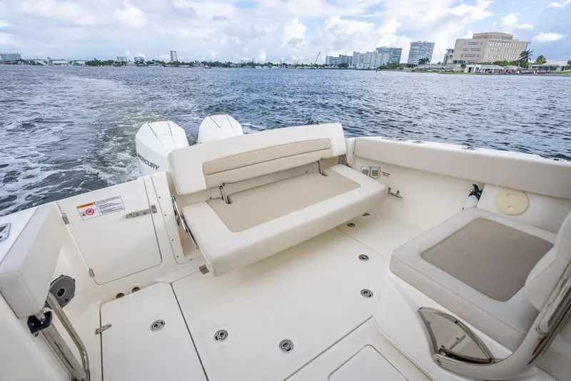 Trade In-- Bring All Offers & Trades Yacht Photos Pics 2024 Boston Whaler 320 Vantage boat interior with seating, on a scenic waterway.