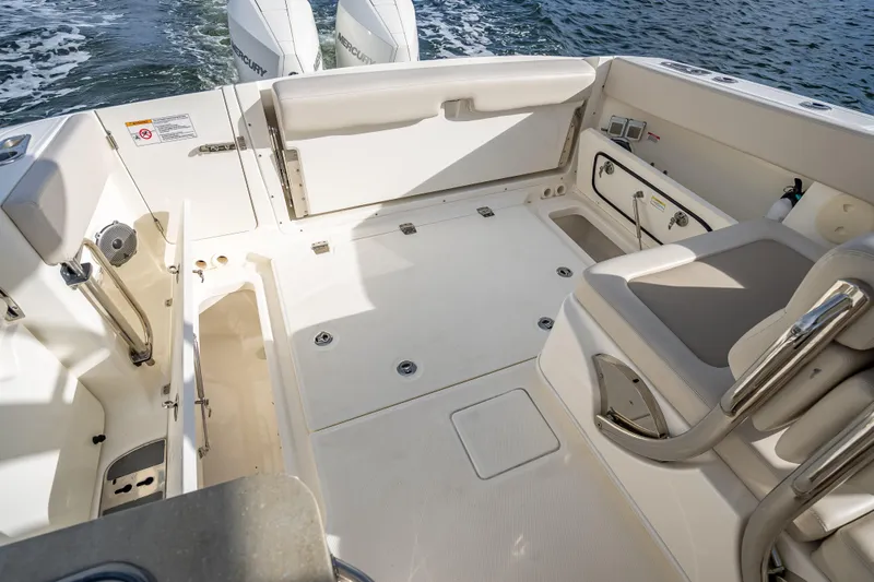 Trade In-- Bring All Offers & Trades Yacht Photos Pics 2024 Boston Whaler 320 Vantage boat interior with seating and storage, on water.