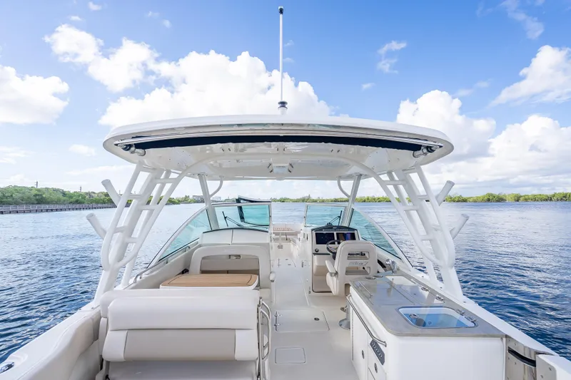 Trade In-- Bring All Offers & Trades Yacht Photos Pics 2024 Boston Whaler 320 Vantage boat interior with seating and helm, on a sunny day.