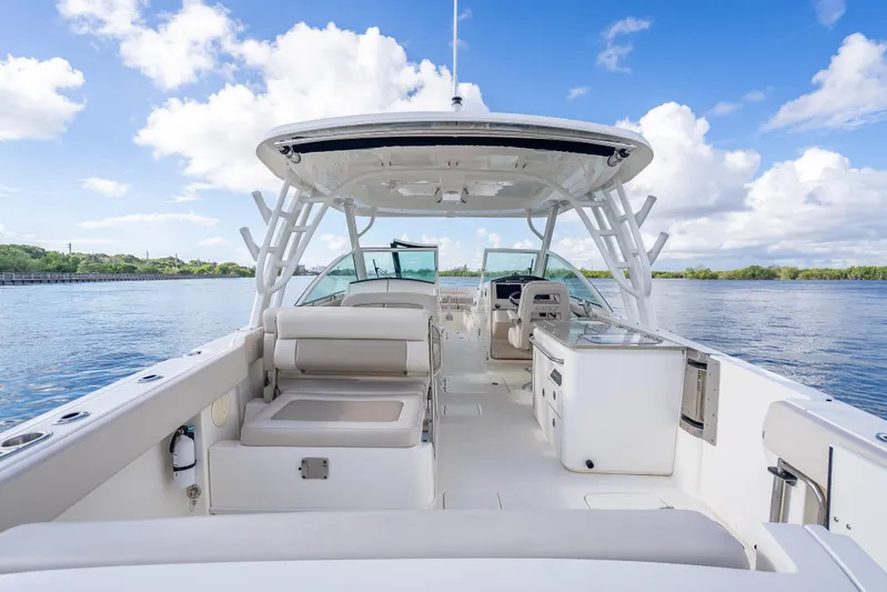 Trade In-- Bring All Offers & Trades Yacht Photos Pics 2024 Boston Whaler 320 Vantage boat interior, featuring spacious seating and modern amenities on calm water.