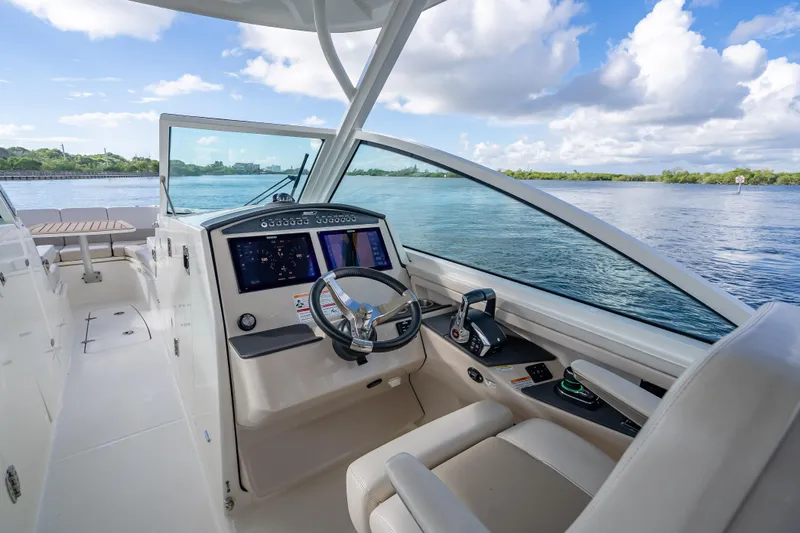Trade In-- Bring All Offers & Trades Yacht Photos Pics 2024 Boston Whaler 320 Vantage boat interior with modern dashboard and scenic water view.