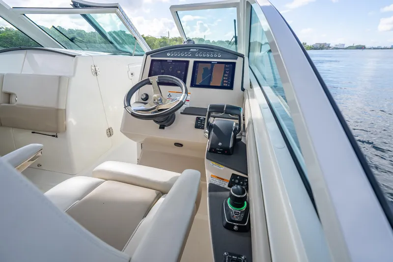 Trade In-- Bring All Offers & Trades Yacht Photos Pics 2024 Boston Whaler 320 Vantage helm with modern controls and navigation display.