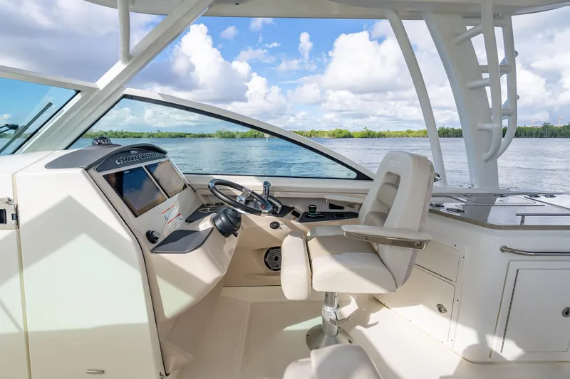 Trade In-- Bring All Offers & Trades Yacht Photos Pics 2024 Boston Whaler 320 Vantage helm with modern controls and scenic water view.