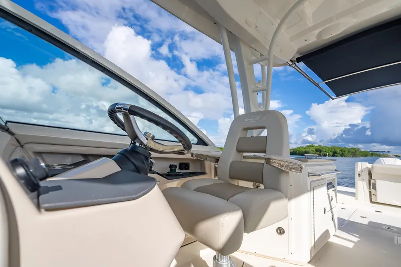 Trade In-- Bring All Offers & Trades Yacht Photos Pics 2024 Boston Whaler 320 Vantage helm with luxurious seating and scenic water view.