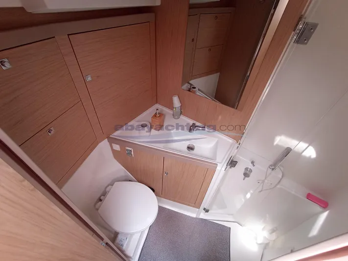  Yacht Photos Pics Bathroom interior of 2016 Beneteau Oceanis 45 yacht, featuring modern fixtures and wood cabinetry.
