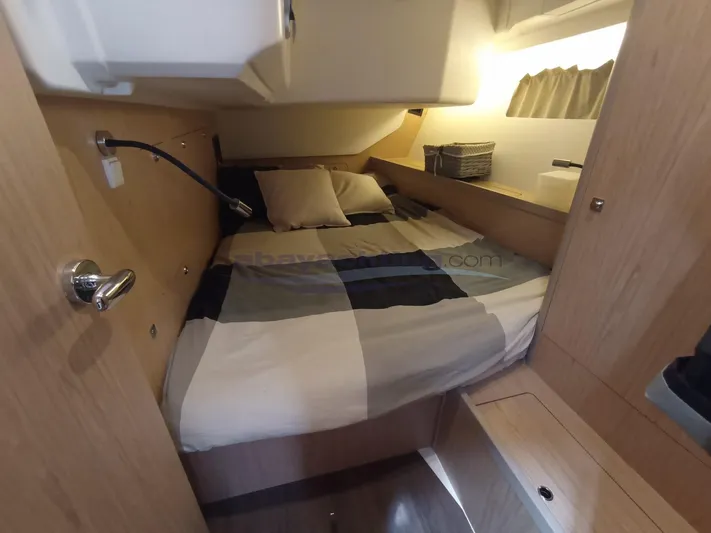  Yacht Photos Pics Cozy cabin interior of 2016 Beneteau Oceanis 45 sailboat with bed and storage.