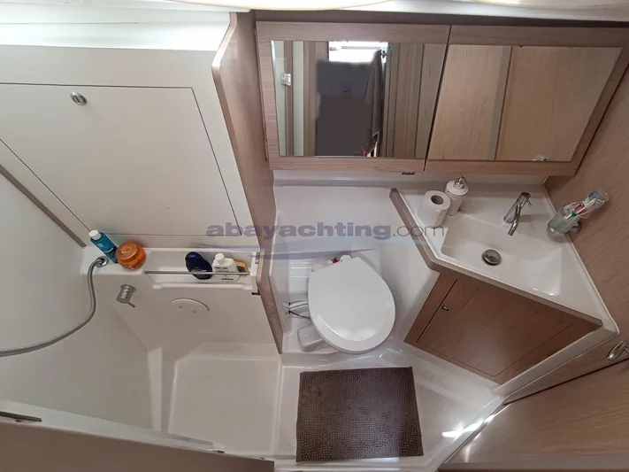  Yacht Photos Pics 2016 Beneteau Oceanis 45 bathroom with modern fixtures and ample storage space.