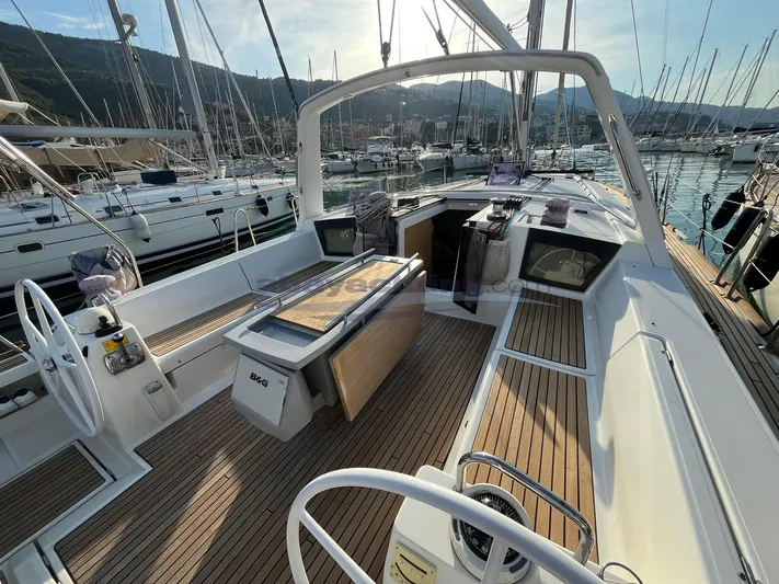 Yacht Photos Pics 2016 Beneteau Oceanis 45 sailboat cockpit with teak decking, docked in a marina.