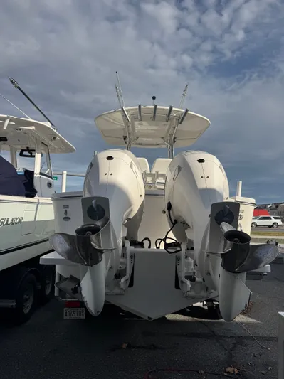 25 Regulator In Stock Yacht Photos Pics 2018 Regulator 25 boat with dual outboard motors, docked under a cloudy sky.