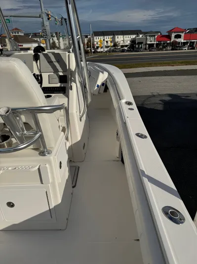 25 Regulator In Stock Yacht Photos Pics 2018 Regulator 25 boat interior with seating and control panel, docked near a road.