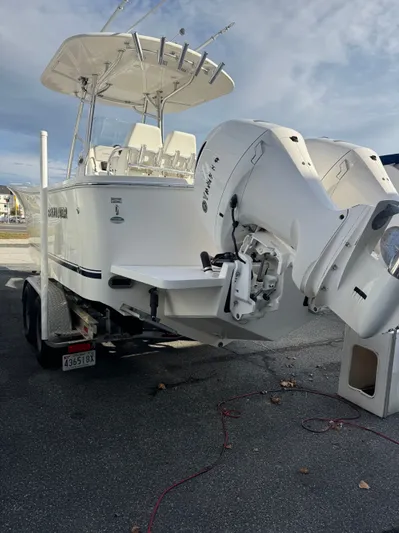 25 Regulator In Stock Yacht Photos Pics 2018 Regulator 25 boat on trailer with dual outboard engines, parked outdoors.