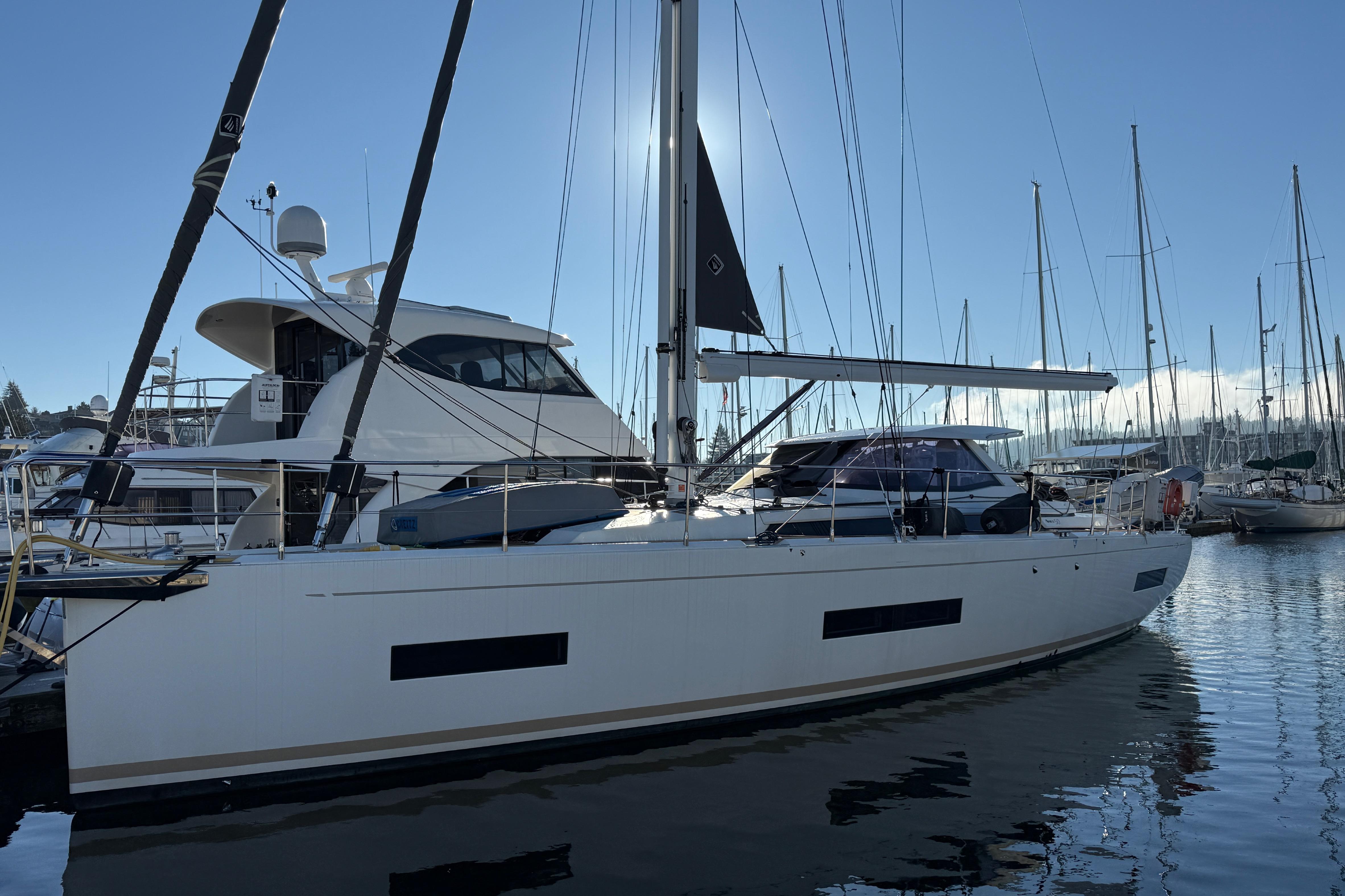2020 Amel 50 yacht docked in a marina under clear blue skies.