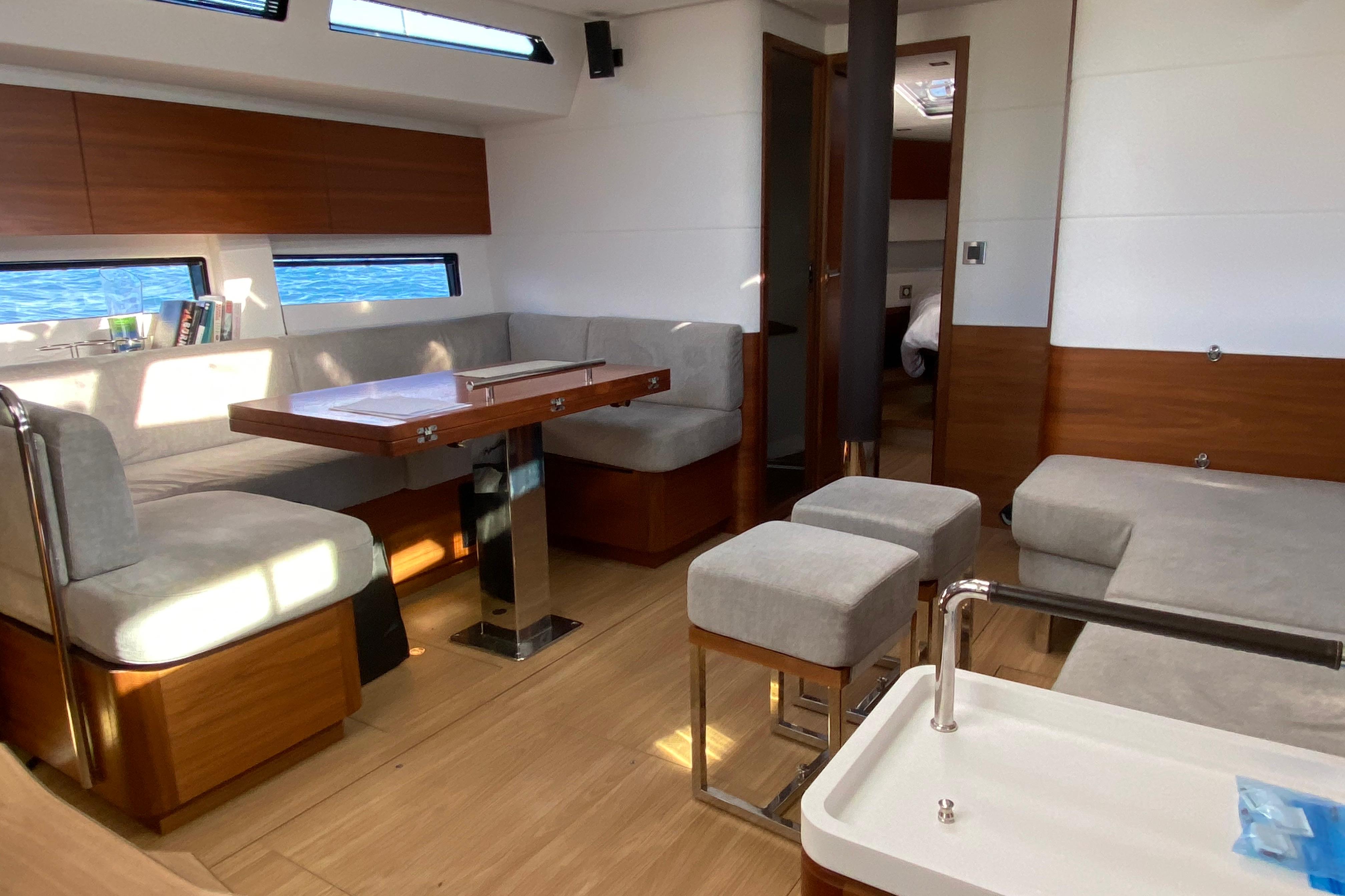Luxurious interior of a 2020 Amel 50 yacht with modern seating and dining area.