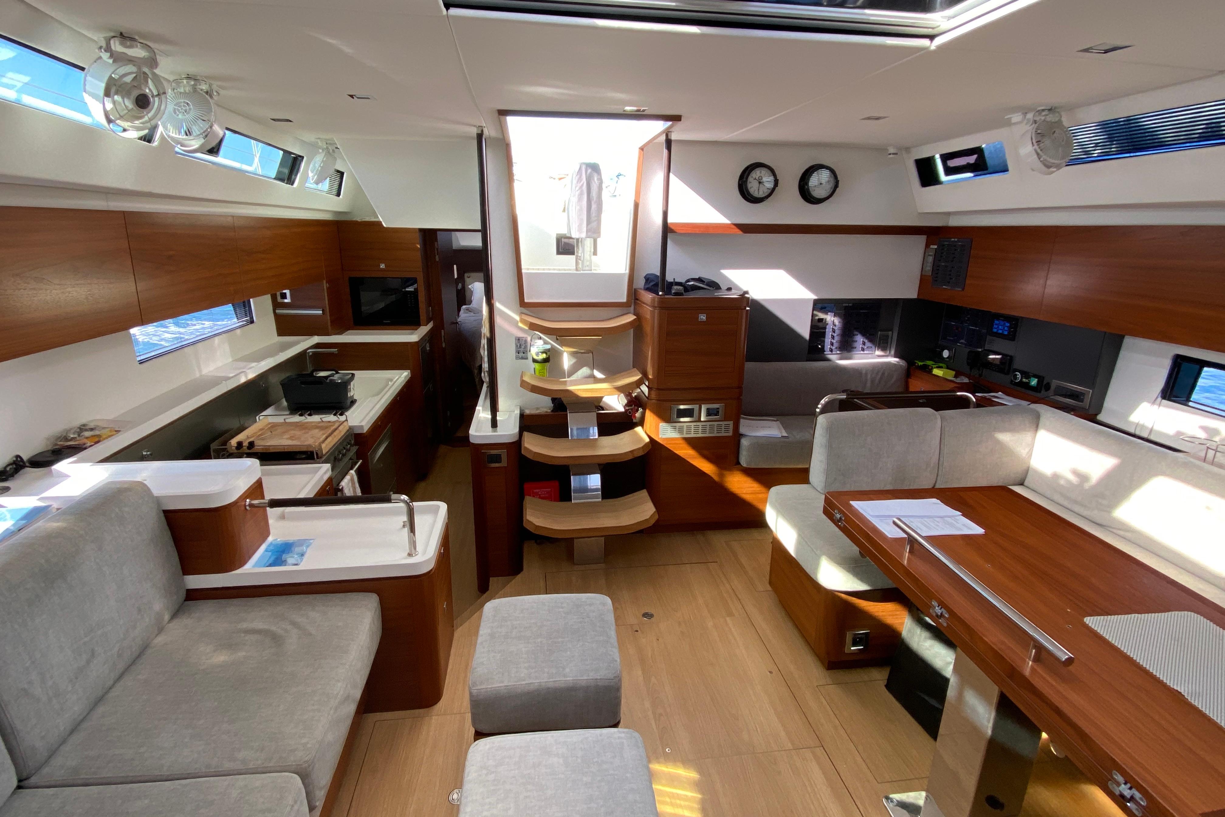 Luxurious interior of a 2020 Amel 50 yacht with modern furnishings and wood accents.